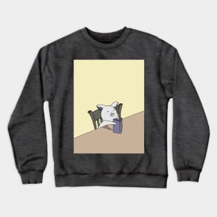 A cute pig reading a book that he is holding in his hands and looking very confused Crewneck Sweatshirt